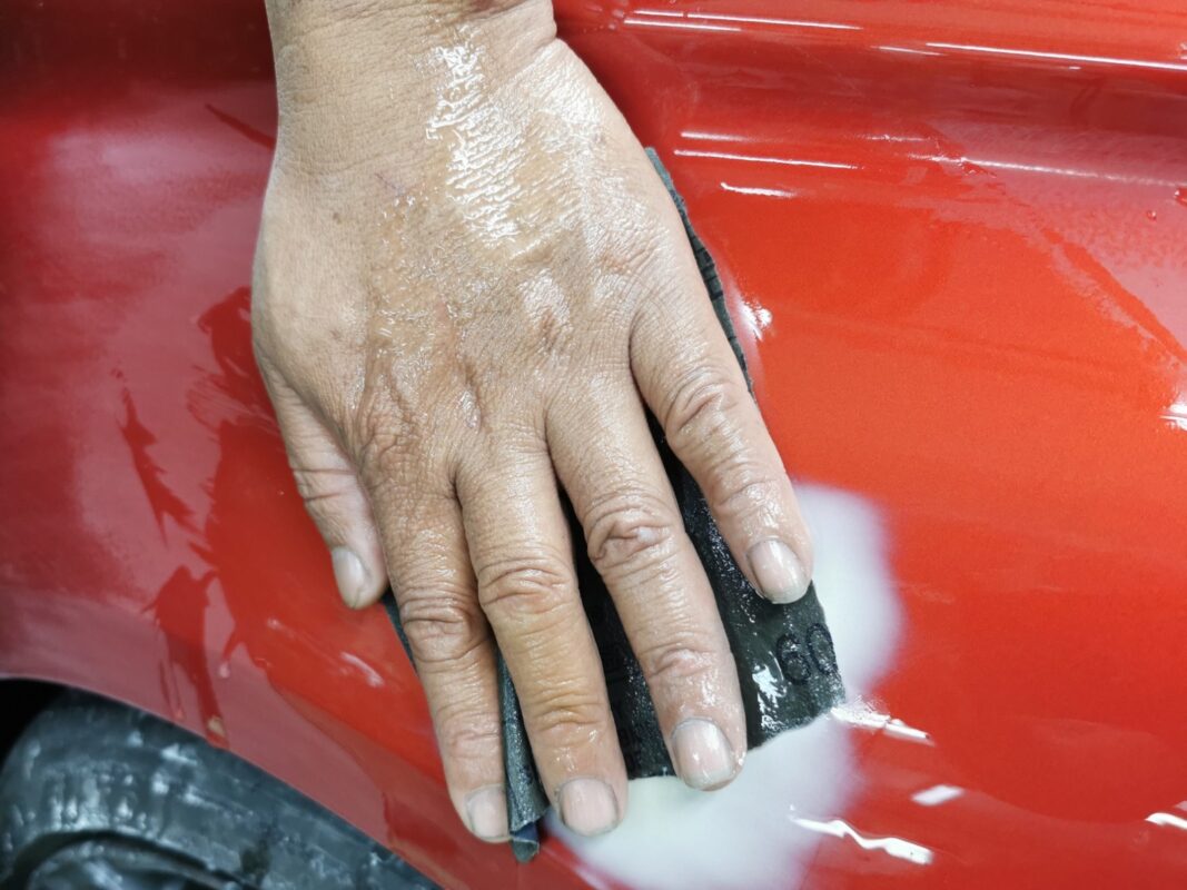 Wet-sanding the BMW M4 smooth after priming.