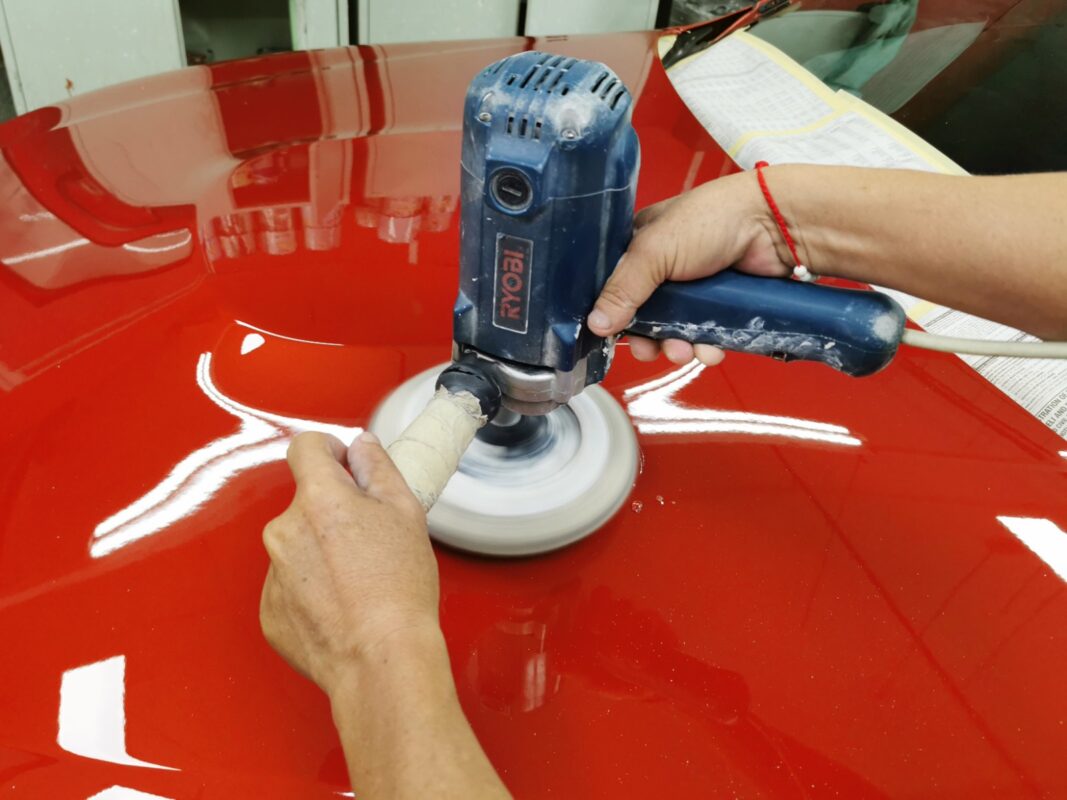 Compound-polishing the BMW M4's hood to a mirror finish.