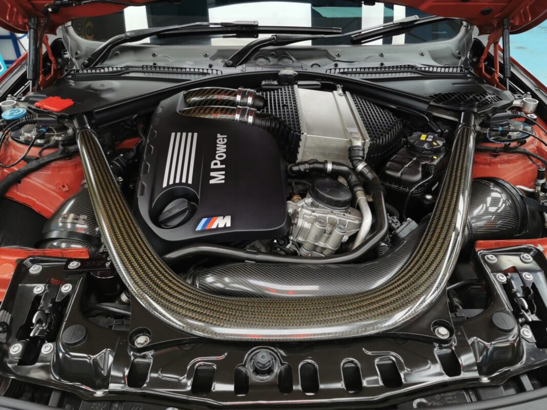 The BMW M4's M Power engine bay, clean after the work.