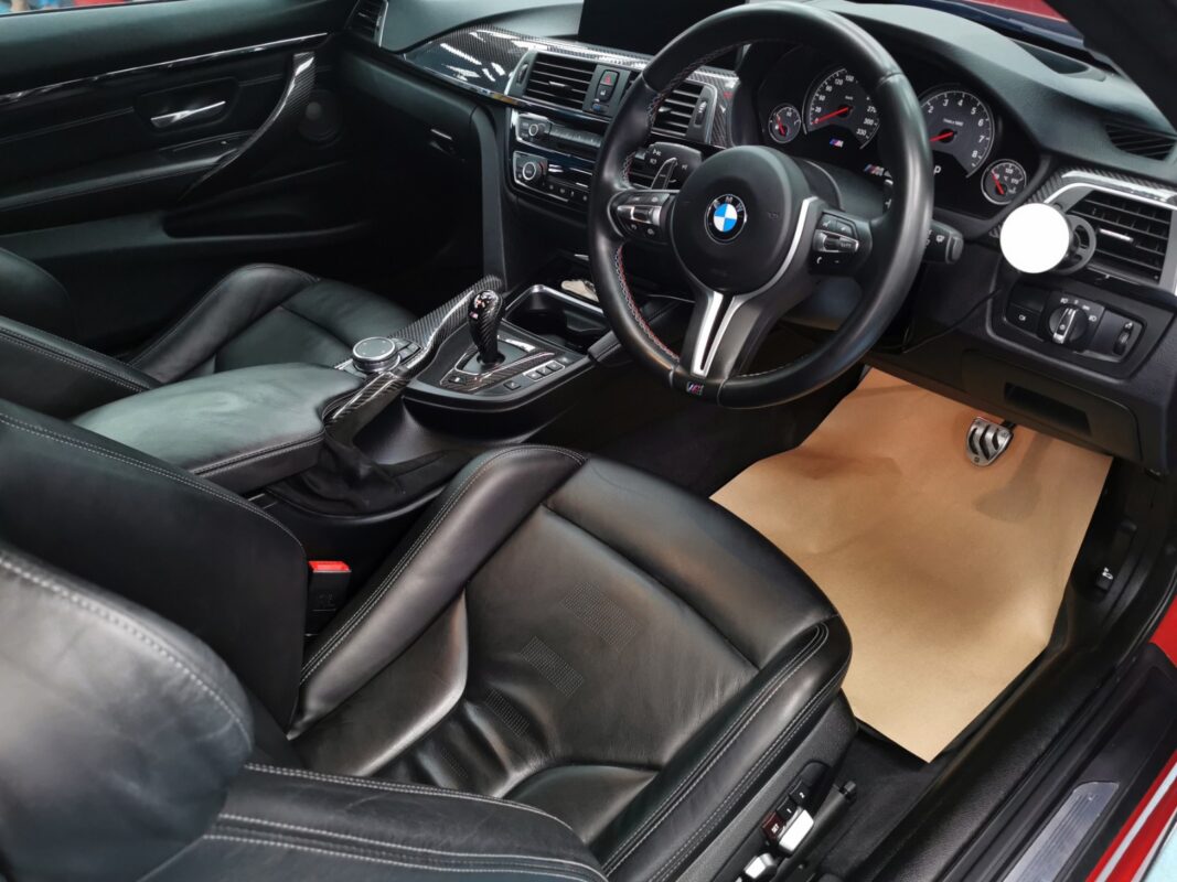 The BMW M4's black interior, cleaned and detailed.