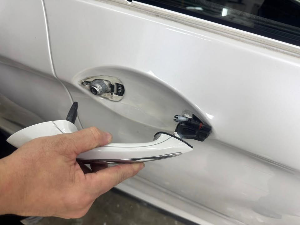 Door handle being removed from the white door.