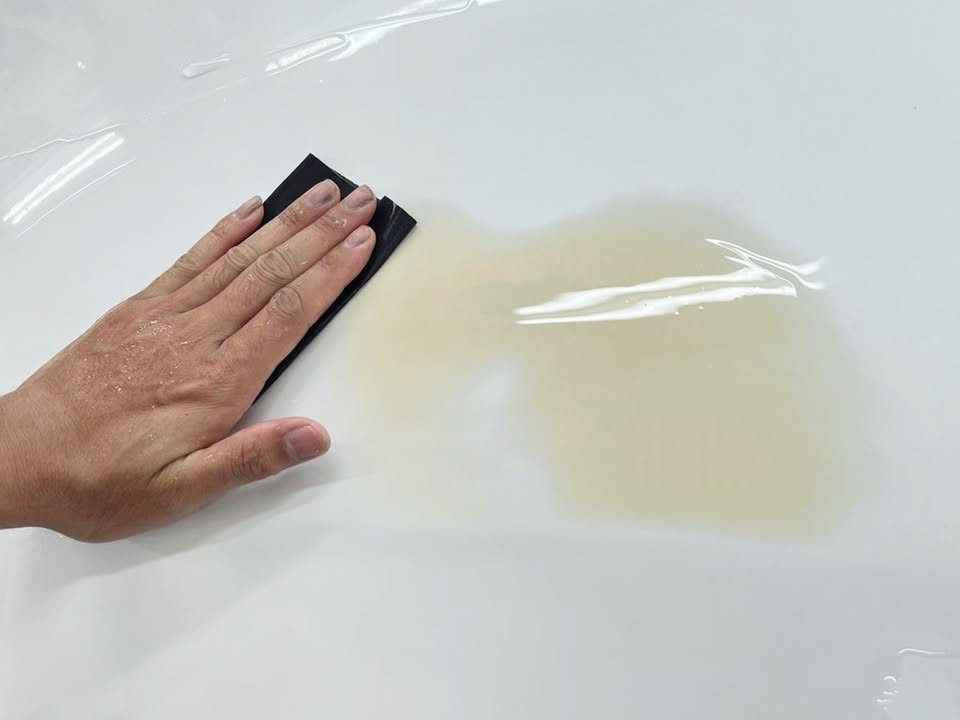 Wet sanding a patched area on the M5's panel.