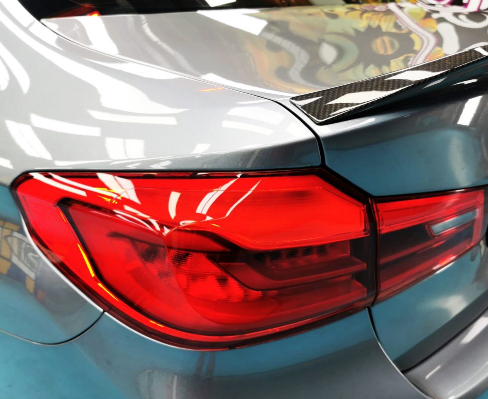 The coated bonnet of the M5 under workshop lighting.