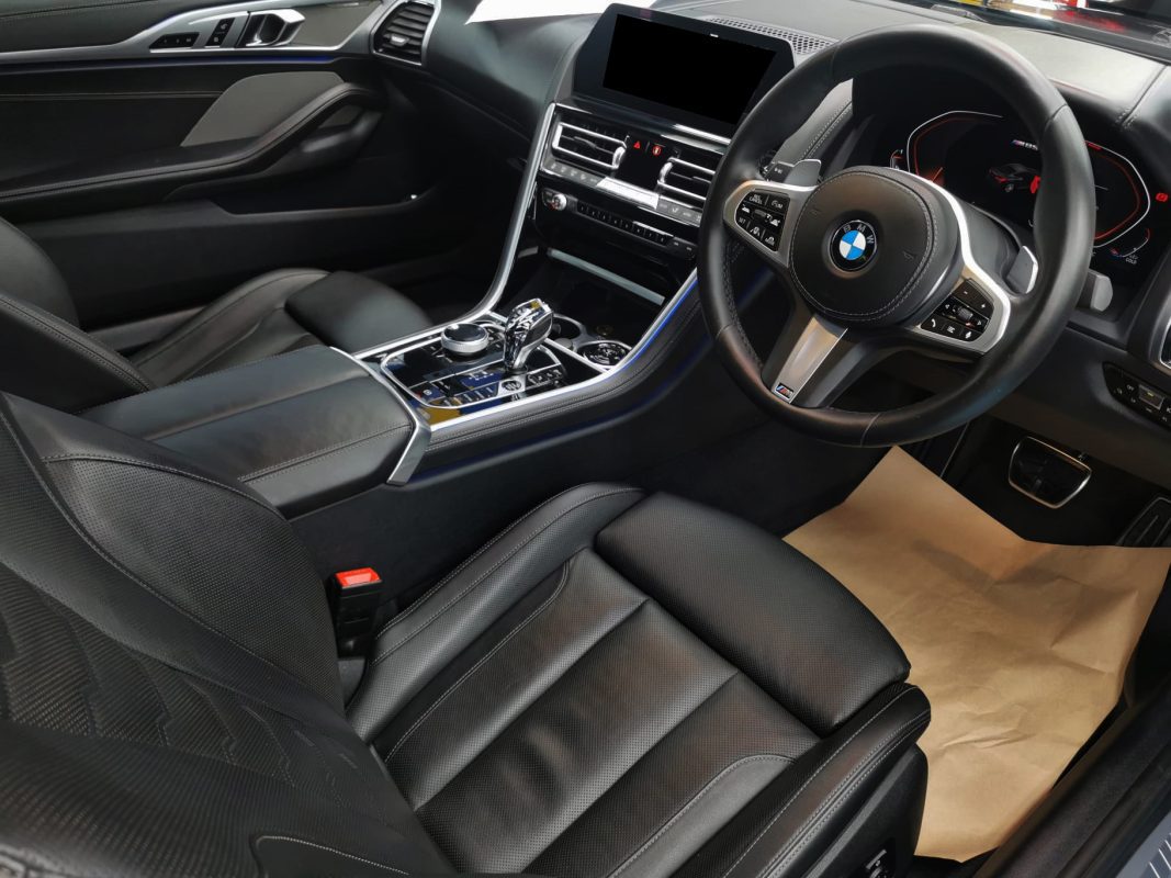 The BMW M850i parked in the workshop, freshly coated.