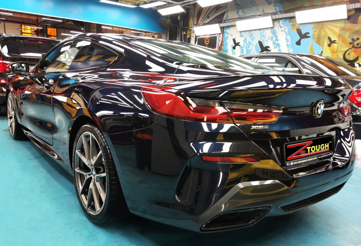 Rear quarter of the BMW M850i, glossy and protected.
