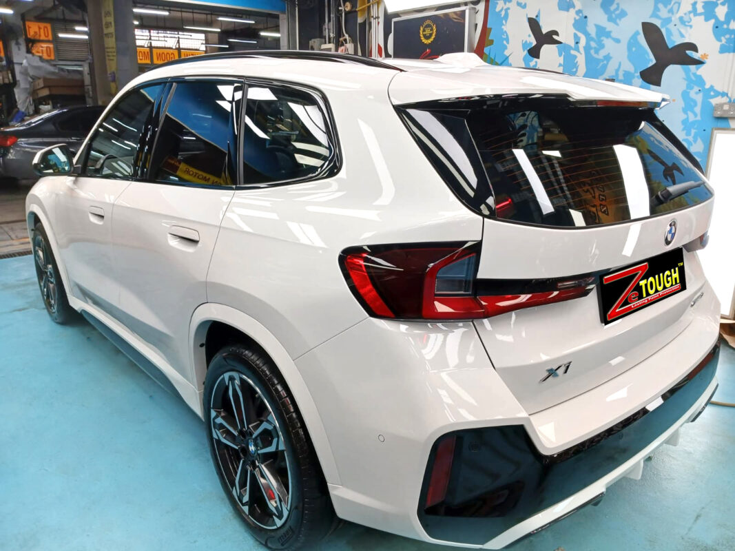 Rear quarter of the BMW X1, glossy and protected.