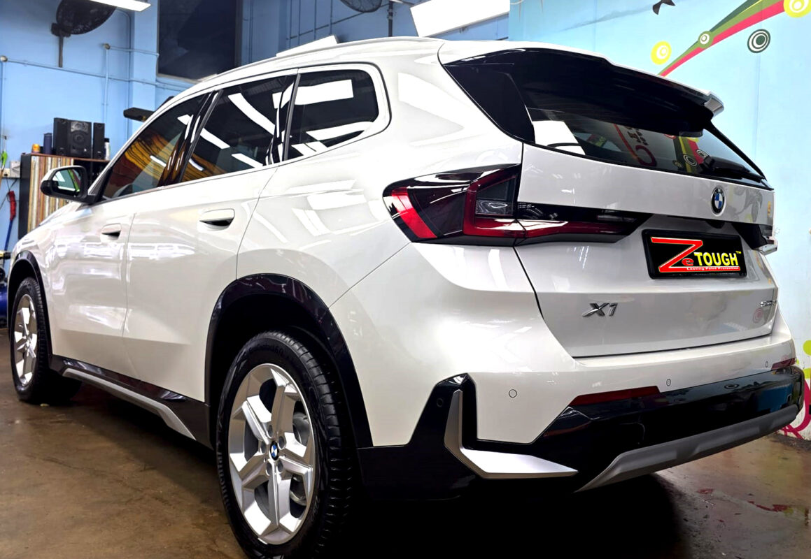 Rear quarter of the BMW X1, glossy and protected.