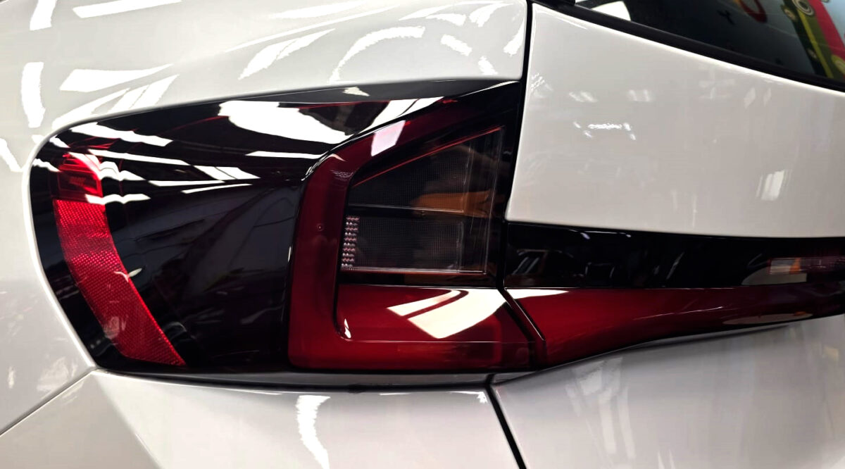 The coated bonnet of the BMW X1 under workshop lighting.