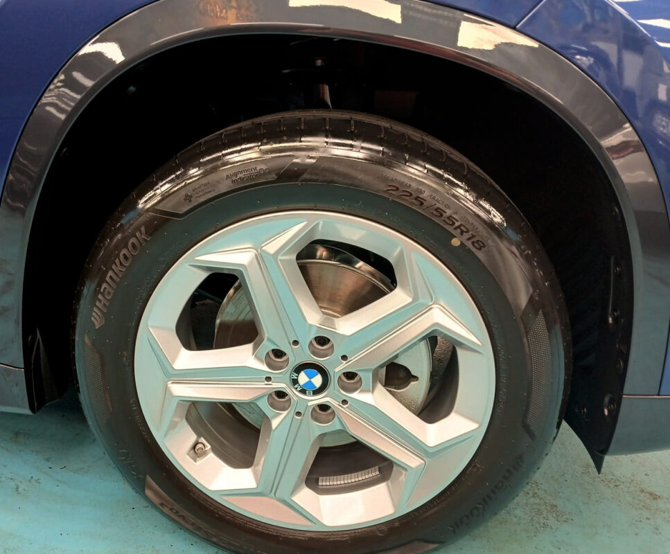 Rear quarter of the BMW X1, glossy and protected.
