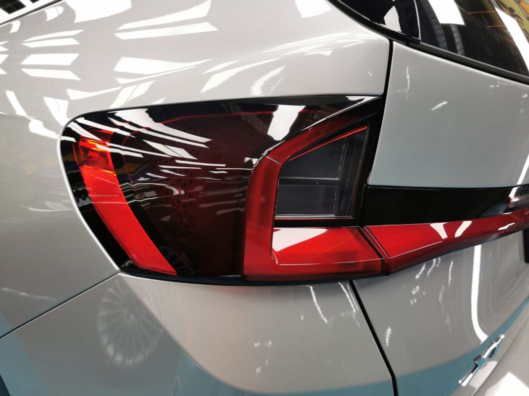 The coated bonnet of the BMW X1 under workshop lighting.