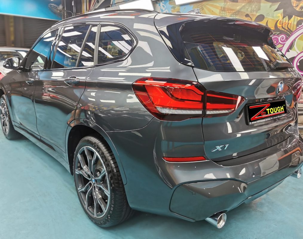 Rear quarter of the BMW X1, glossy and protected.