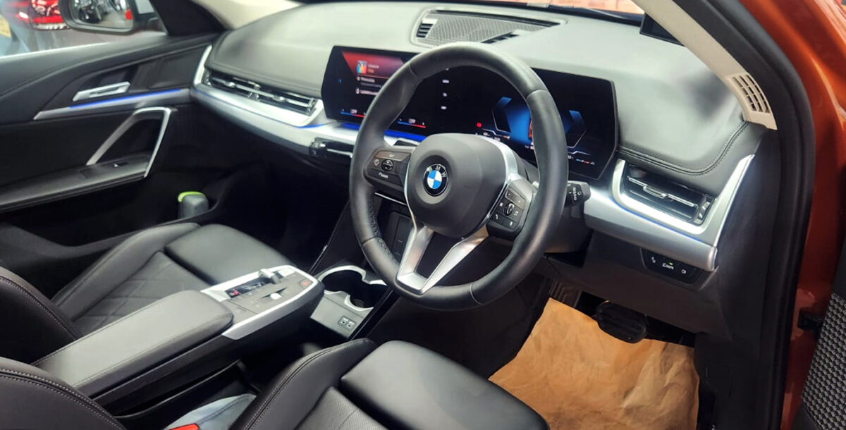 The BMW X1 parked in the workshop, freshly coated.