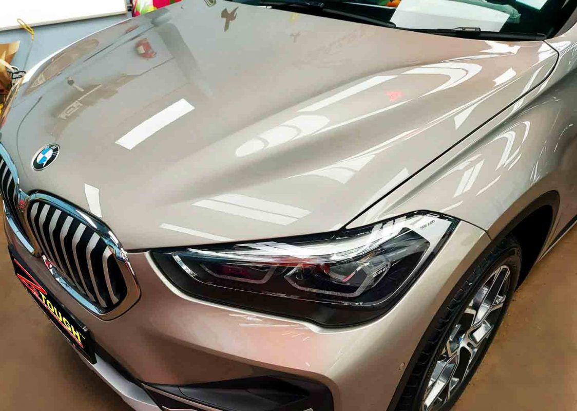 The BMW X1 from a side angle after the ceramic coating.