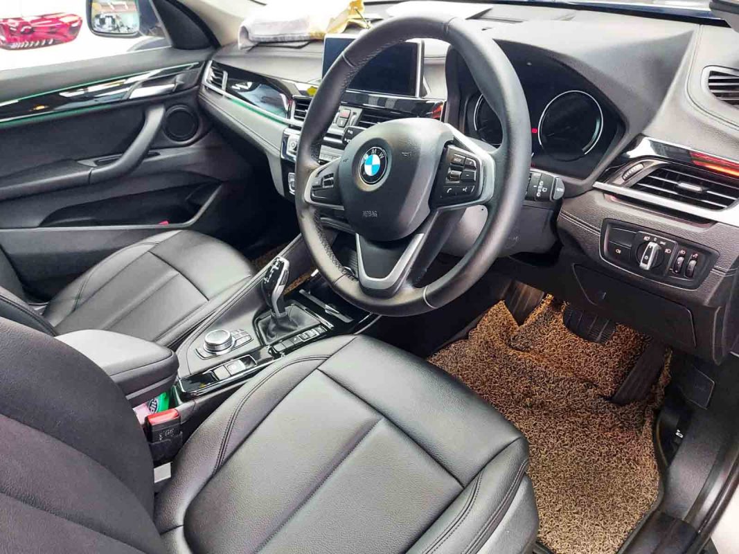 The BMW X1 parked in the workshop, freshly coated.