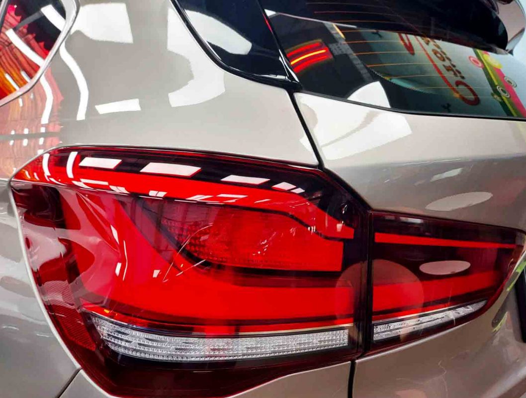 The coated bonnet of the BMW X1 under workshop lighting.
