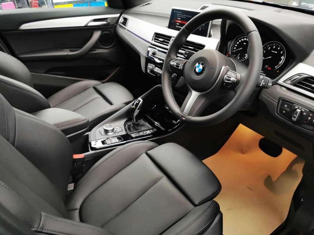The BMW X1 parked in the workshop, freshly coated.