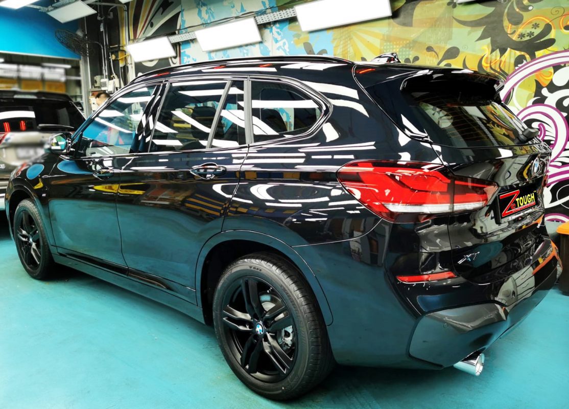 Rear quarter of the BMW X1, glossy and protected.