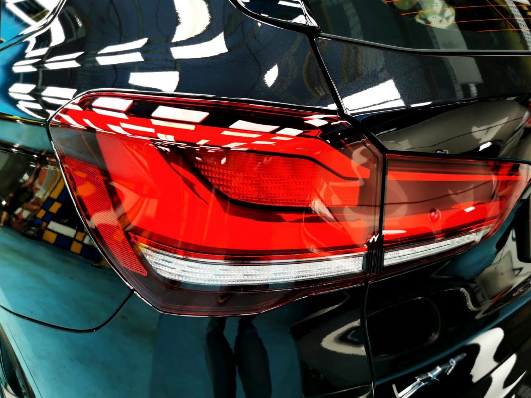 The coated bonnet of the BMW X1 under workshop lighting.