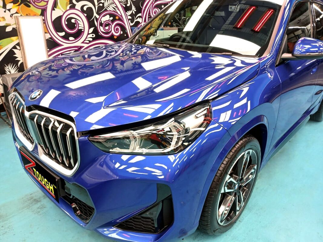 The BMW X1 from a side angle after the ceramic coating.