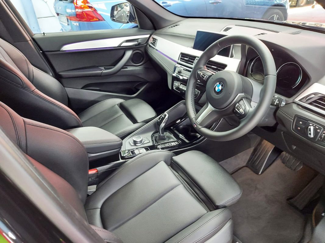 The BMW X1 parked in the workshop, freshly coated.