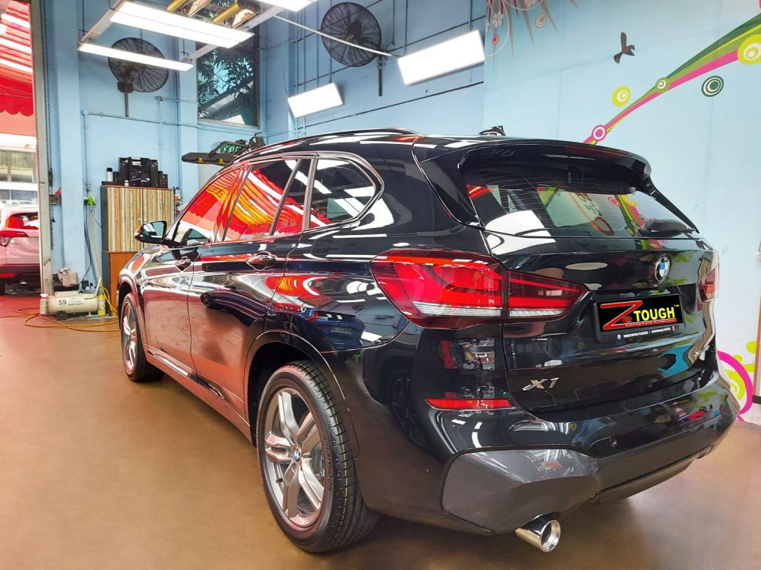 Rear quarter of the BMW X1, glossy and protected.