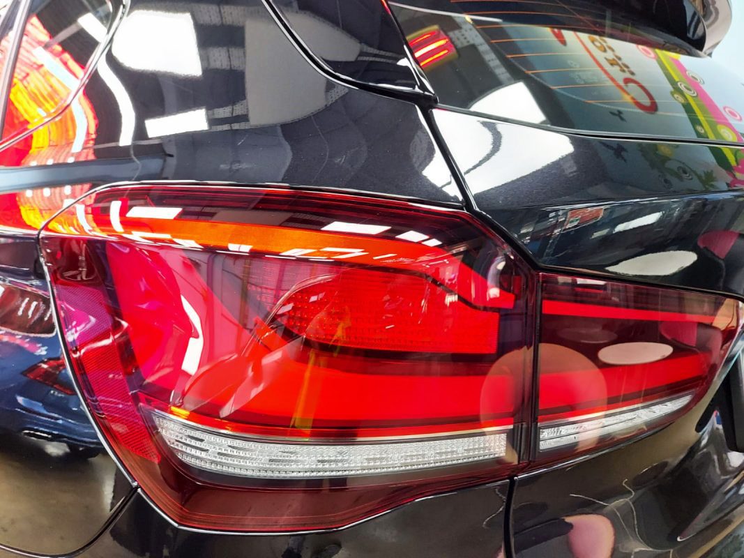The coated bonnet of the BMW X1 under workshop lighting.