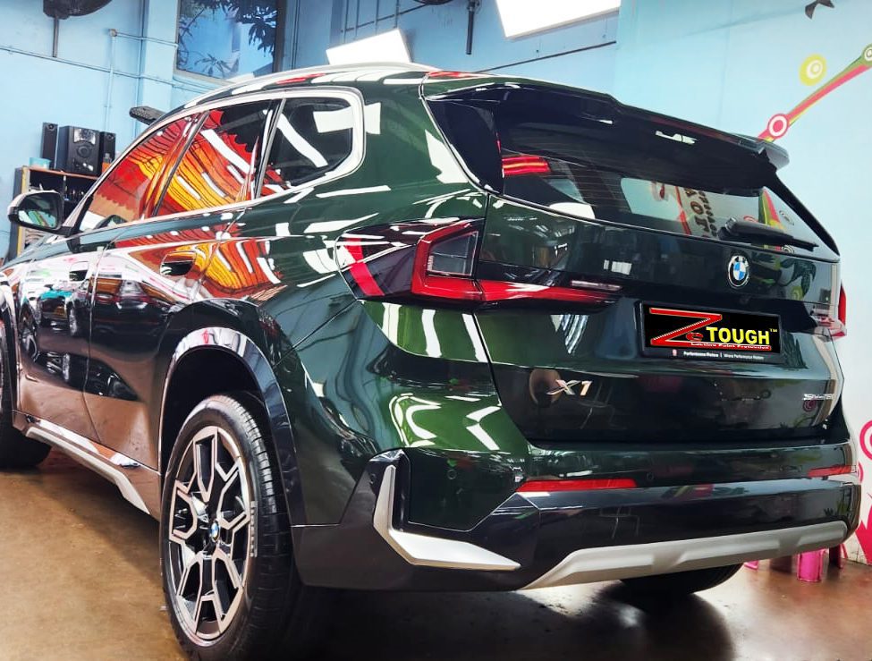 Rear quarter of the BMW X1, glossy and protected.