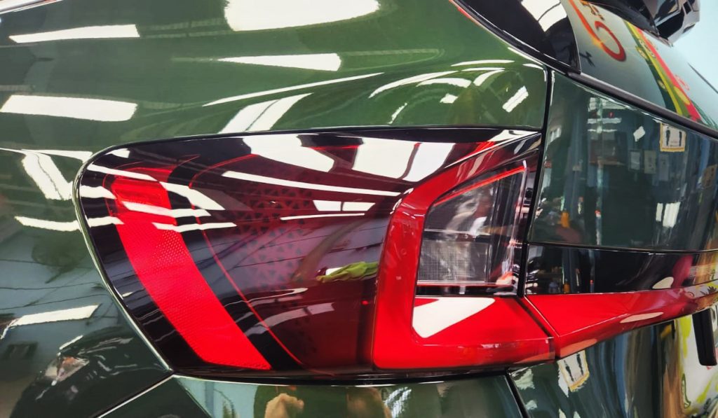 The coated bonnet of the BMW X1 under workshop lighting.