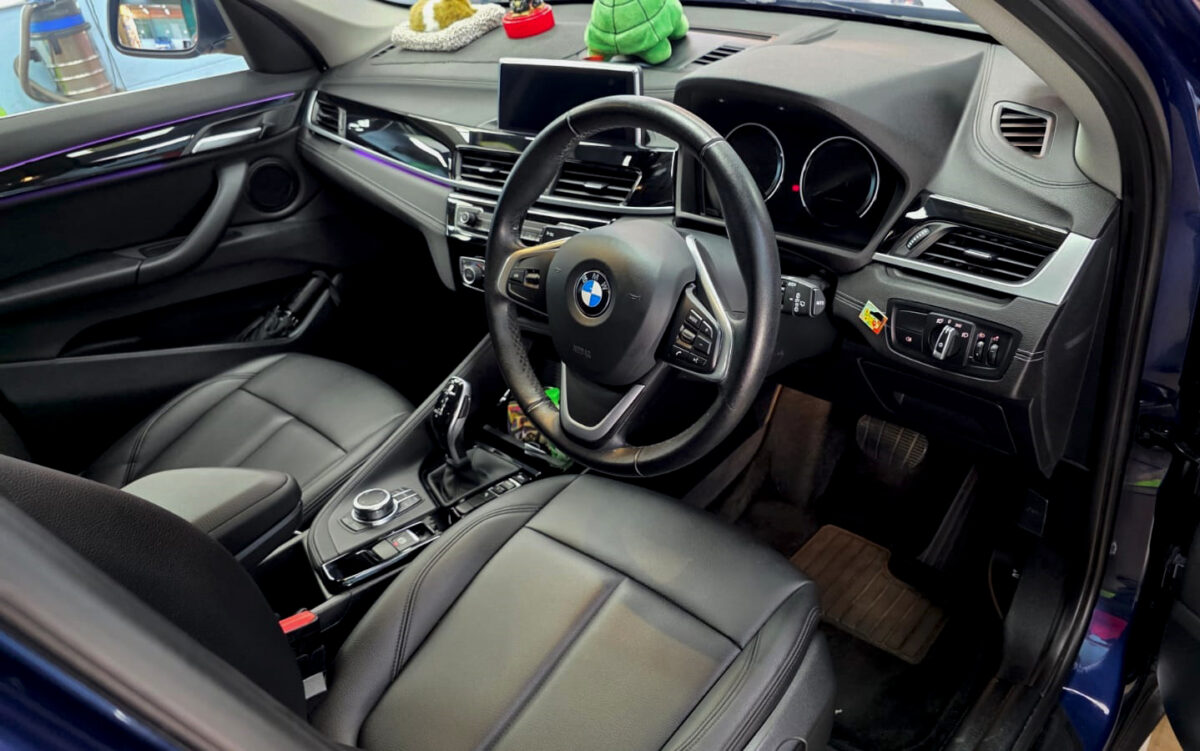 The BMW X1 parked in the workshop, freshly coated.