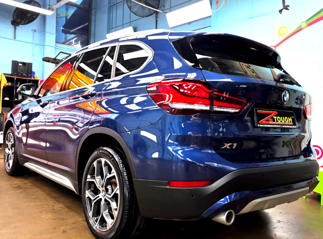 Rear quarter of the BMW X1, glossy and protected.