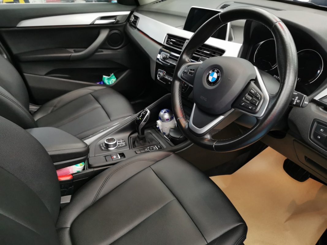 The BMW X1 parked in the workshop, freshly coated.