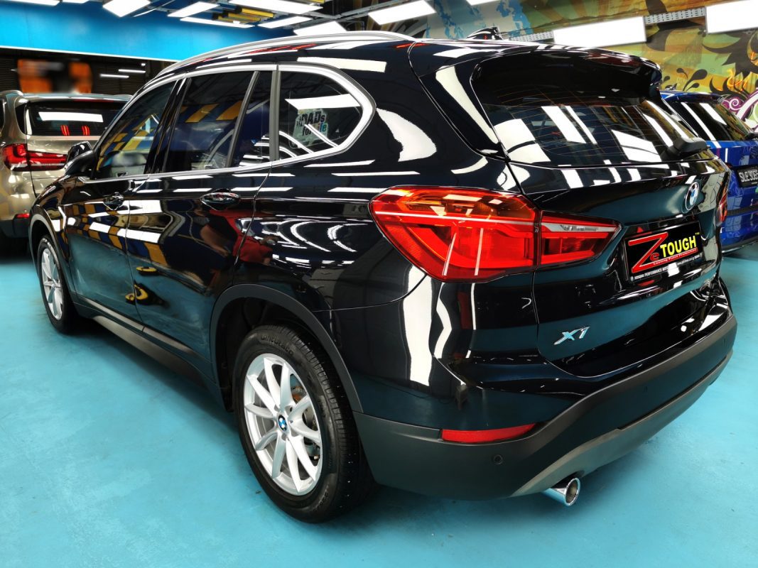 Rear quarter of the BMW X1, glossy and protected.