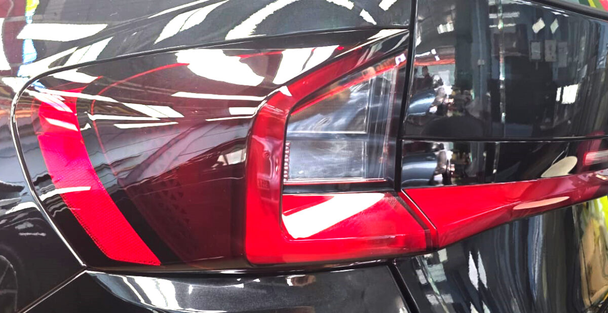 The coated bonnet of the BMW X1 under workshop lighting.