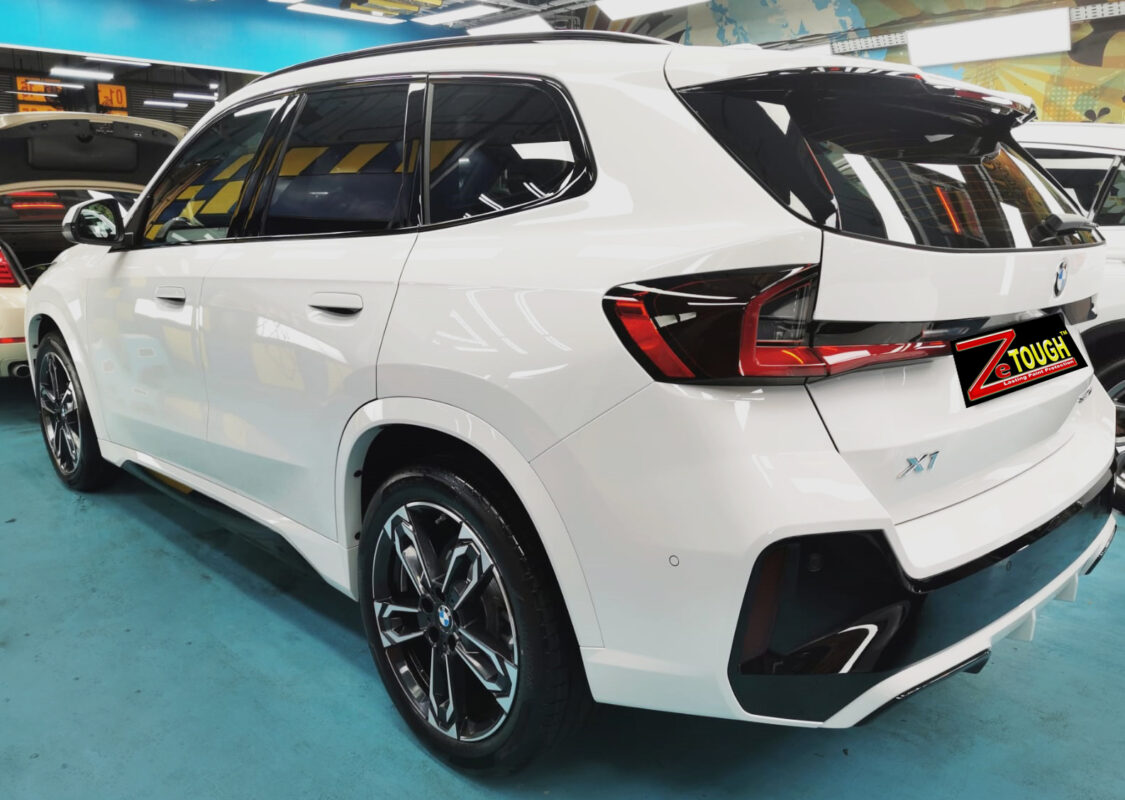Rear quarter of the BMW X1, glossy and protected.