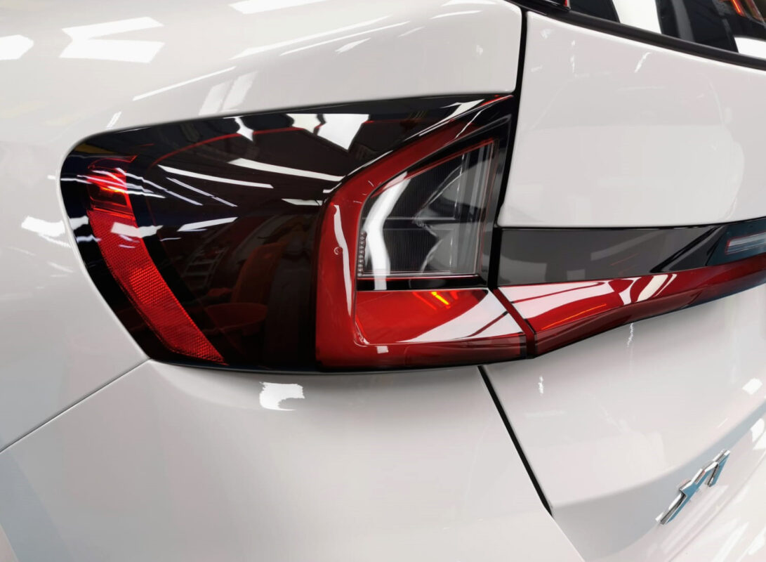 The coated bonnet of the BMW X1 under workshop lighting.