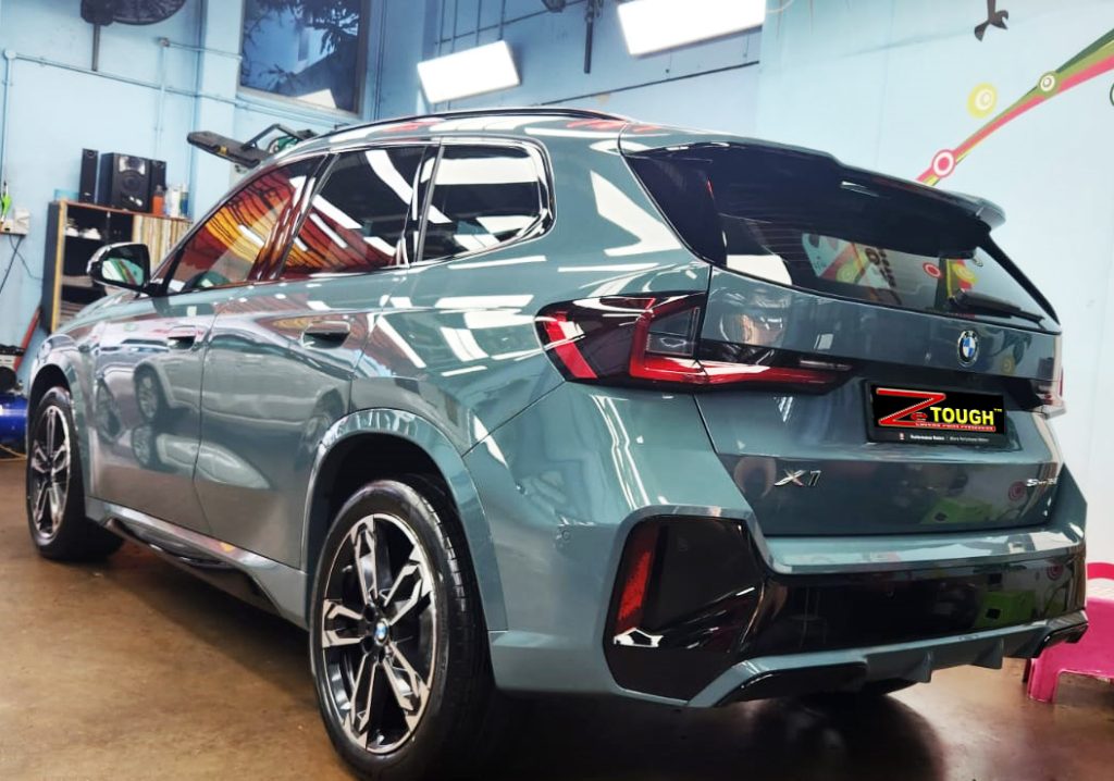 Rear quarter of the BMW X1, glossy and protected.
