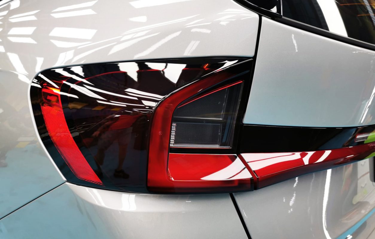 The coated bonnet of the BMW X1 under workshop lighting.
