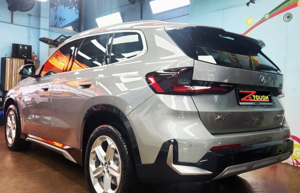 Rear quarter of the BMW X1, glossy and protected.