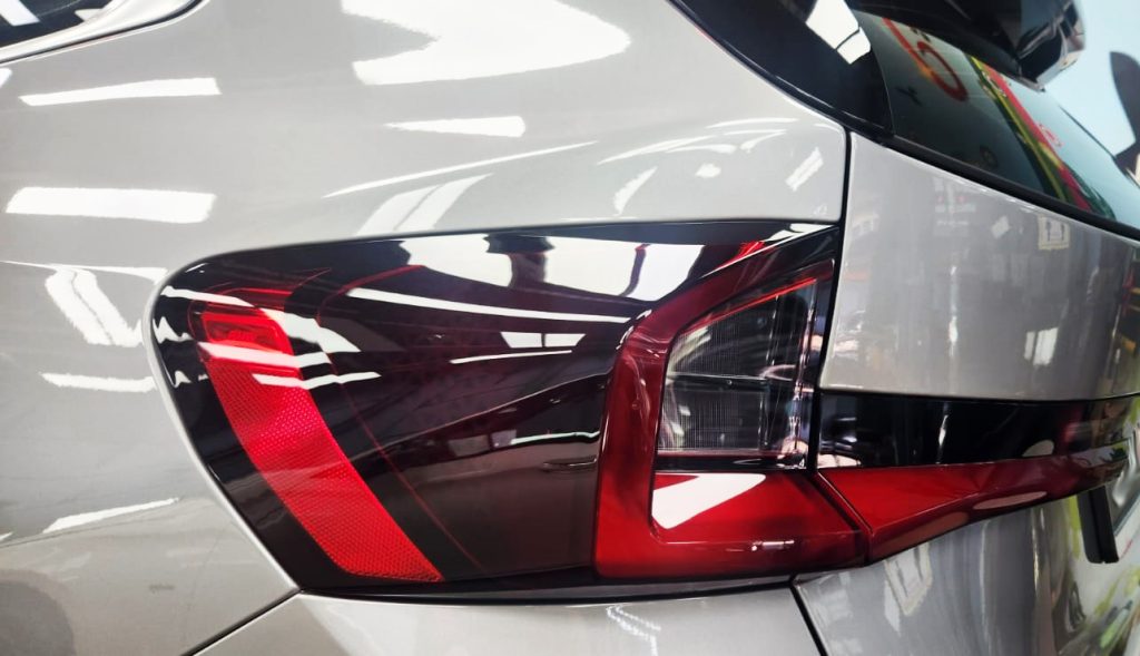 The coated bonnet of the BMW X1 under workshop lighting.