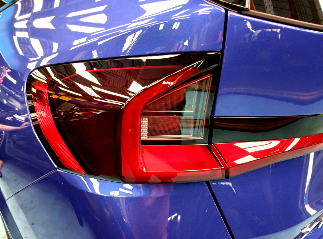 The coated bonnet of the BMW X1 under workshop lighting.