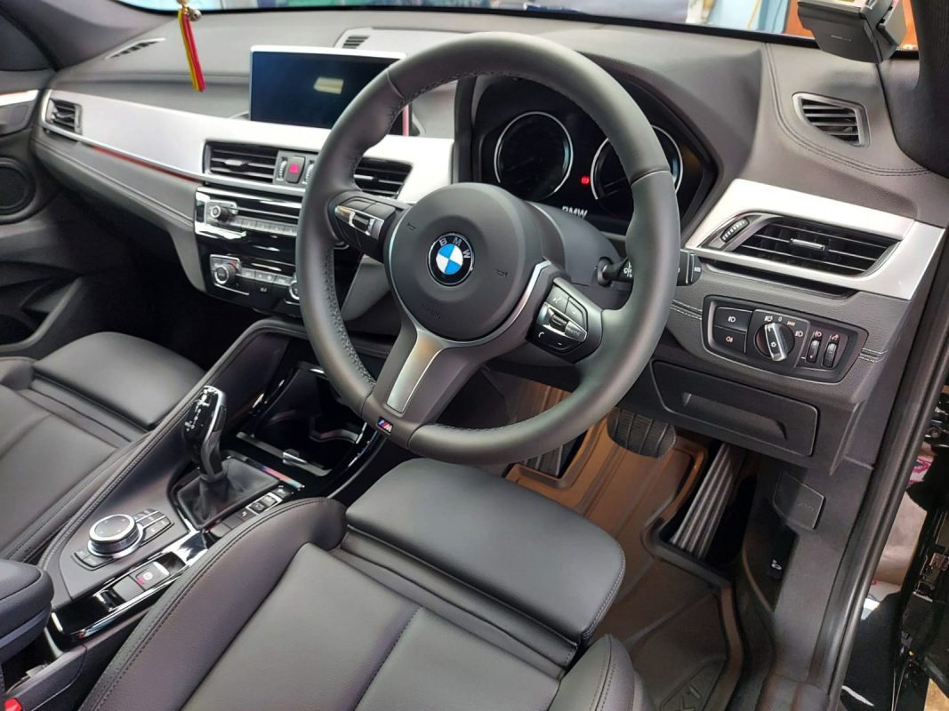 The BMW X1 parked in the workshop, freshly coated.