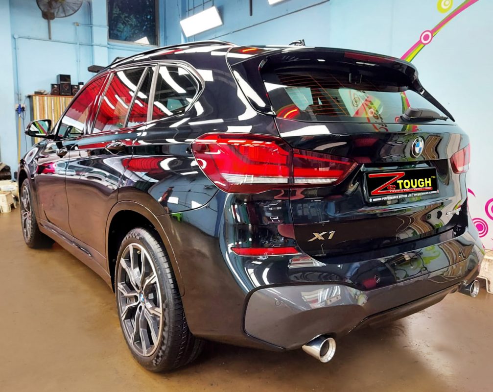 Rear quarter of the BMW X1, glossy and protected.