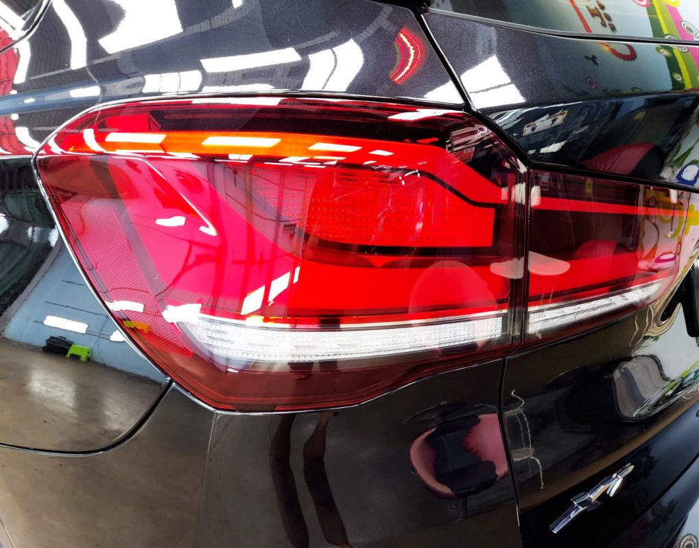 The coated bonnet of the BMW X1 under workshop lighting.