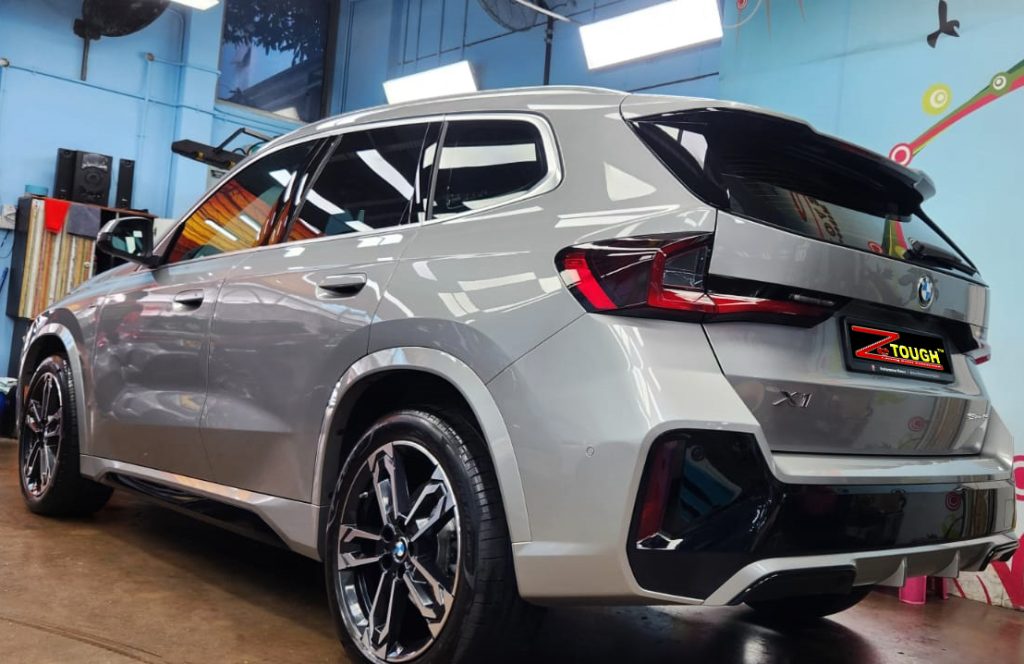 Rear quarter of the BMW X1, glossy and protected.