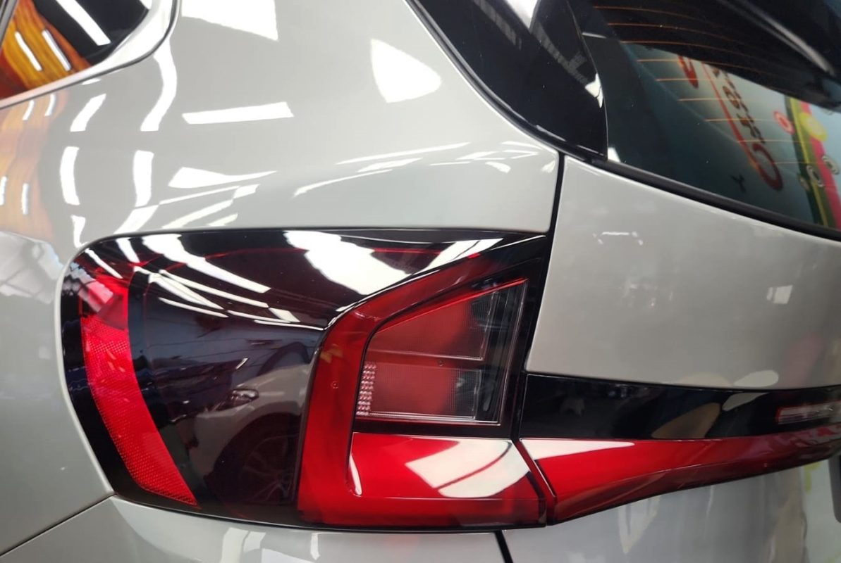 The coated bonnet of the BMW X1 under workshop lighting.