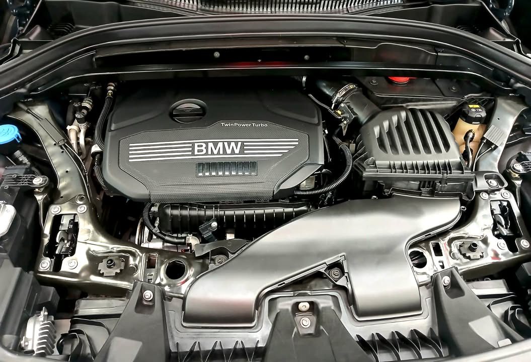 Clean engine bay of the BMW X1 with the BMW engine cover.