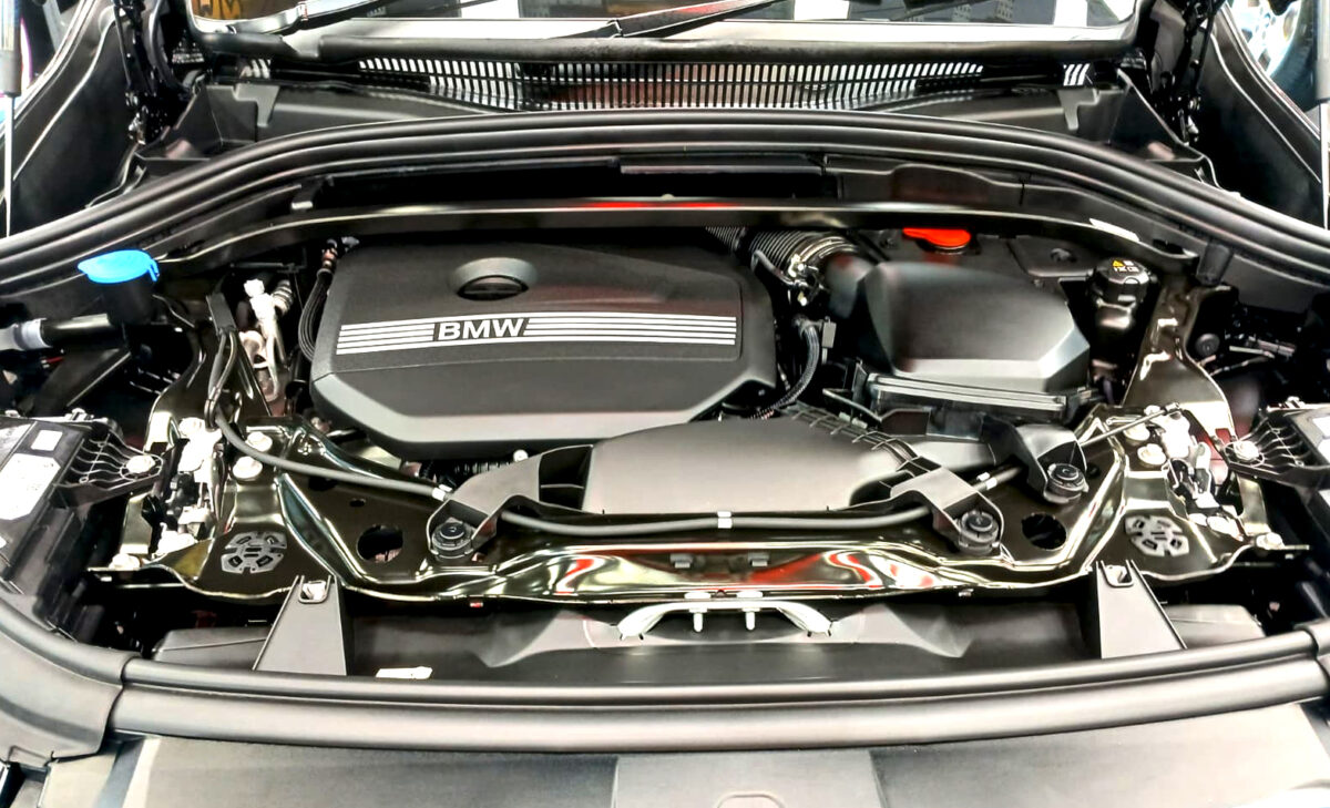Reflections across the coated panels of the BMW X1.