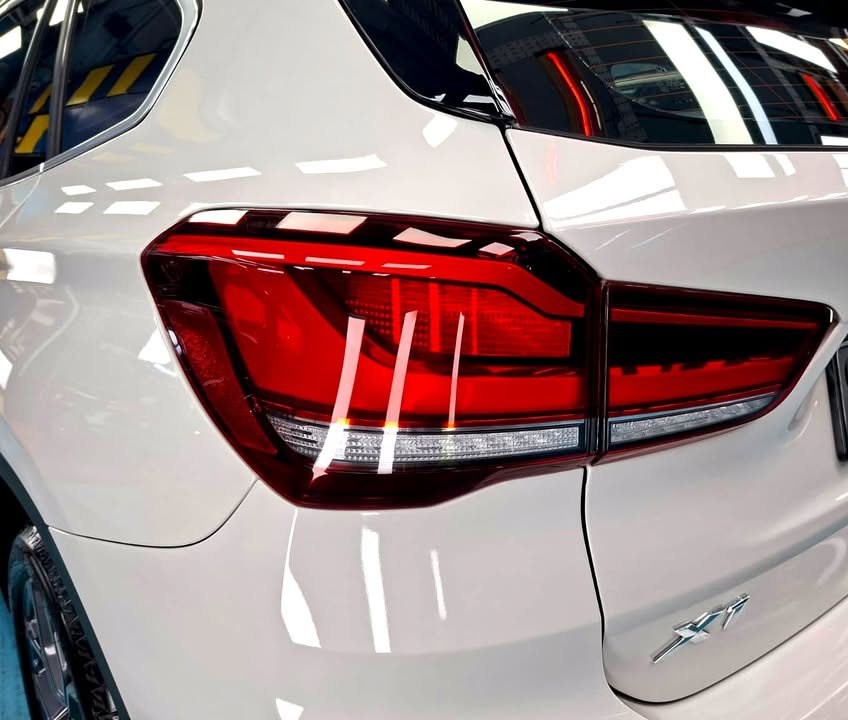 Close-up of the red tail light and X1 badge on the white tailgate.