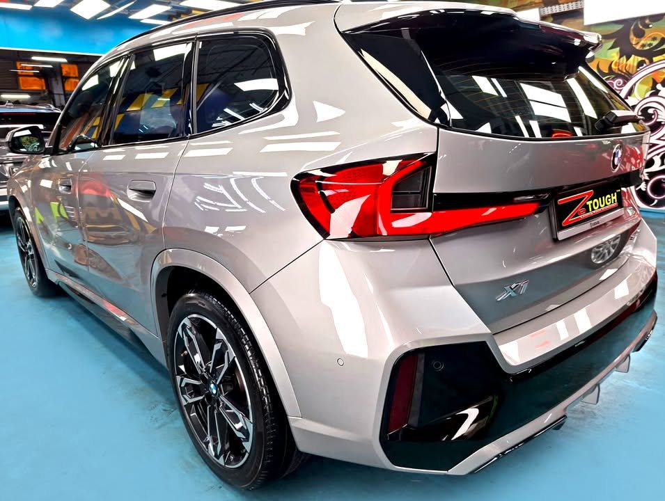 Rear three-quarter view of the grey BMW X1.