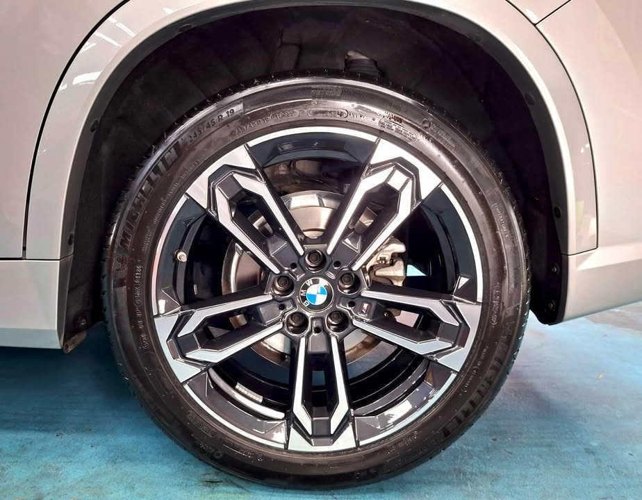 Two-tone multi-spoke alloy wheel under the grey wheel arch.